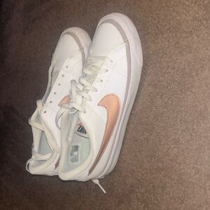 low blazer with rose gold symbol white.